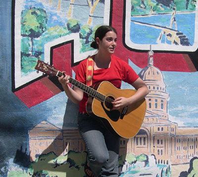 leaning against a mural in South Austin